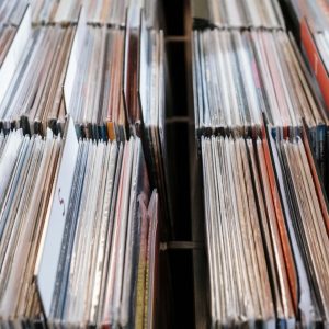 Close-up view of vintage vinyl records in a store setting, showcasing a retro music collection.